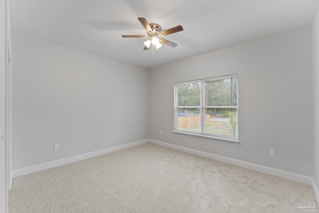 unfurnished room featuring light colored carpet and ceiling fan