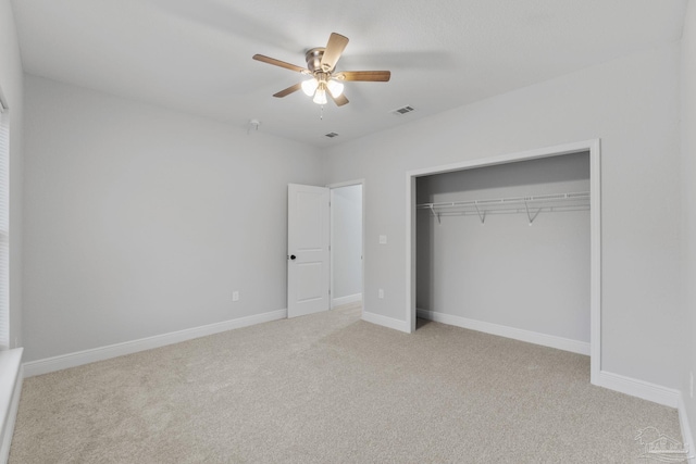 unfurnished bedroom with ceiling fan, a closet, and light colored carpet