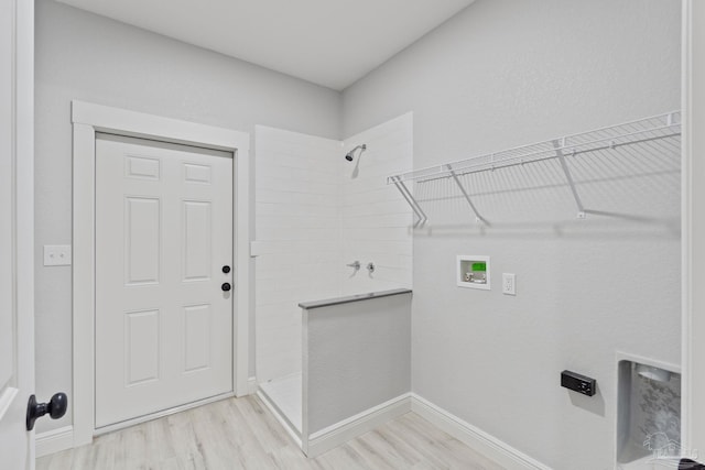 laundry room featuring hookup for a washing machine and light hardwood / wood-style floors