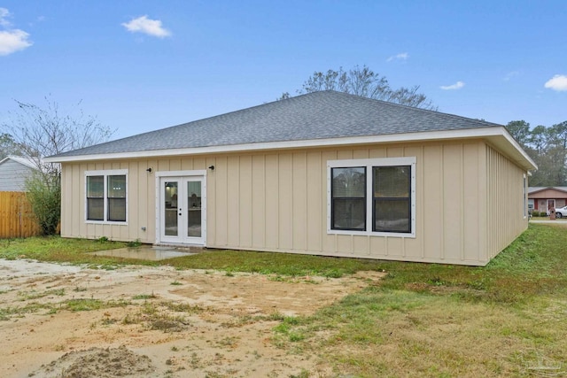 rear view of property with a lawn and french doors