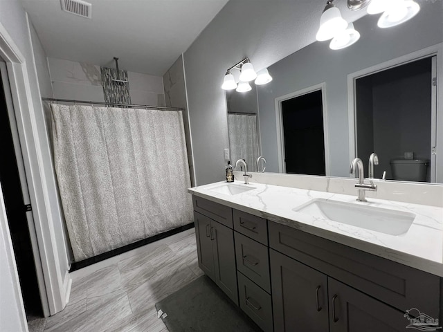 bathroom featuring vanity, curtained shower, and toilet