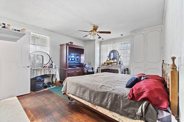 bedroom with dark wood-type flooring and ceiling fan