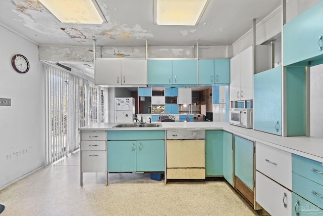 kitchen with white appliances, sink, and white cabinets