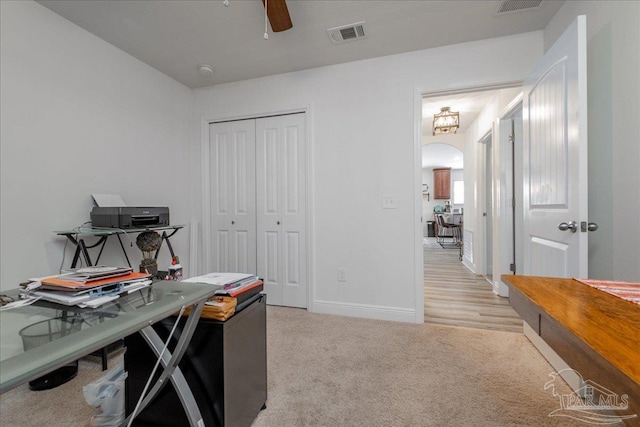 carpeted home office with ceiling fan