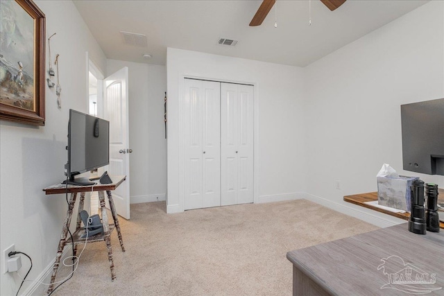 sitting room featuring ceiling fan and light carpet