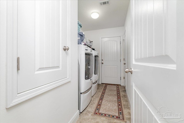 clothes washing area featuring independent washer and dryer and a textured ceiling