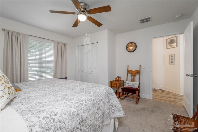 bedroom with light colored carpet, a closet, and ceiling fan