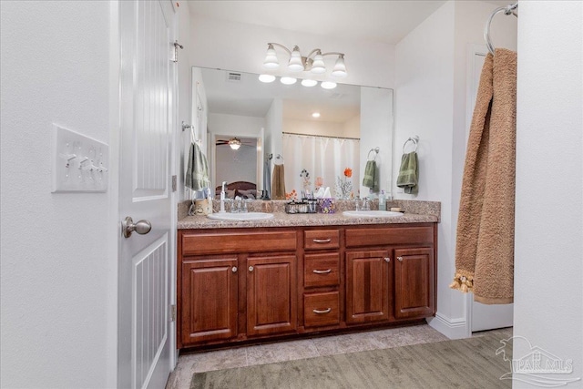 bathroom with ceiling fan and vanity