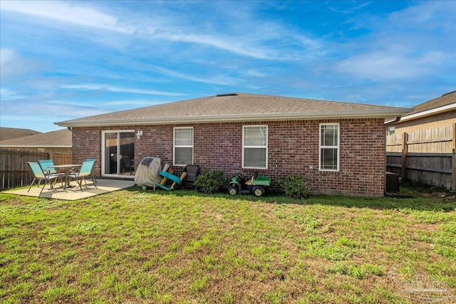 back of property featuring central AC, a patio, and a lawn