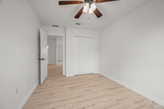 unfurnished bedroom with visible vents, baseboards, and light wood finished floors
