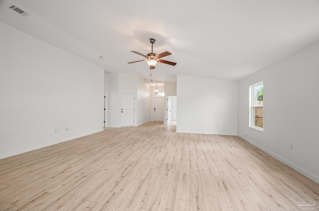 spare room featuring baseboards, ceiling fan, light wood finished floors, and visible vents
