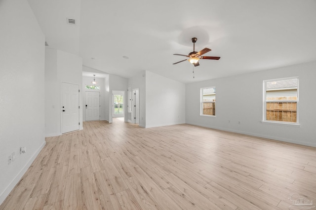 unfurnished living room with visible vents, lofted ceiling, baseboards, a ceiling fan, and light wood finished floors