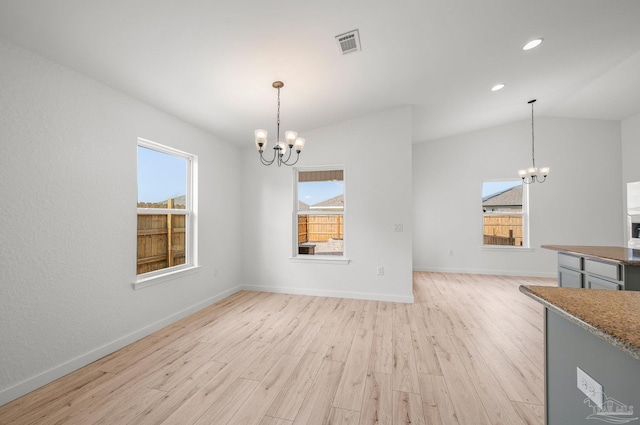 unfurnished dining area with visible vents, plenty of natural light, and a chandelier