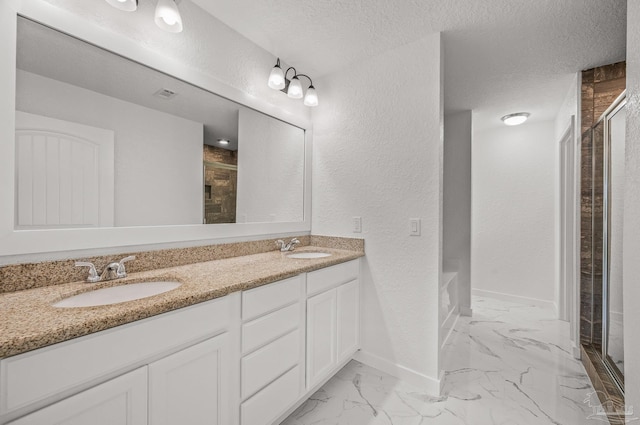 full bathroom featuring a sink, baseboards, a shower stall, and marble finish floor