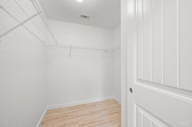 spacious closet featuring visible vents and light wood finished floors