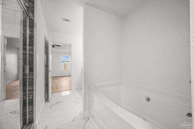 bathroom with baseboards, marble finish floor, a bath, and visible vents
