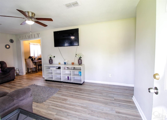 living room with wood-type flooring and ceiling fan