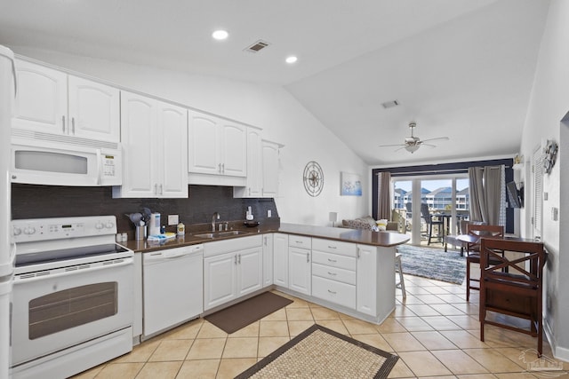 kitchen featuring sink, white appliances, white cabinetry, backsplash, and kitchen peninsula