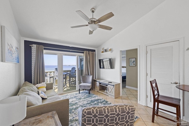 living room featuring vaulted ceiling, ceiling fan, and light tile patterned flooring