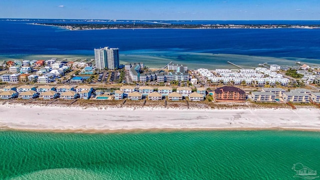 birds eye view of property with a water view and a beach view