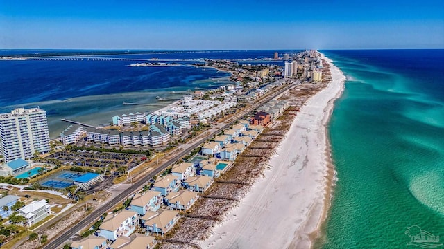 birds eye view of property with a water view and a beach view