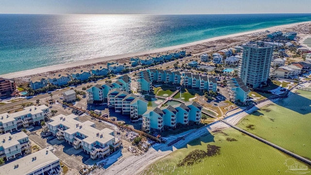 drone / aerial view featuring a water view and a view of the beach