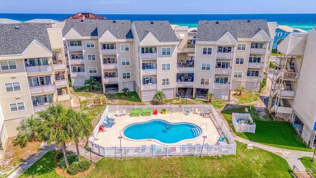 view of swimming pool with a water view and a patio