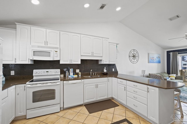 kitchen with white cabinetry, white appliances, and kitchen peninsula