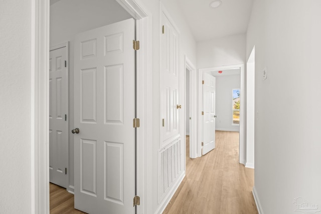 hallway with light hardwood / wood-style flooring