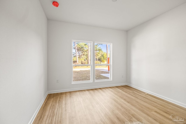 empty room with light hardwood / wood-style flooring