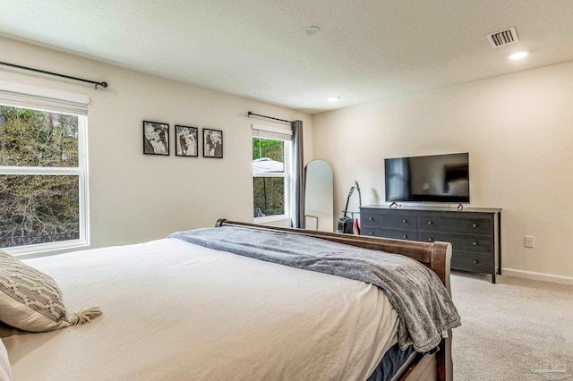 carpeted bedroom featuring a textured ceiling