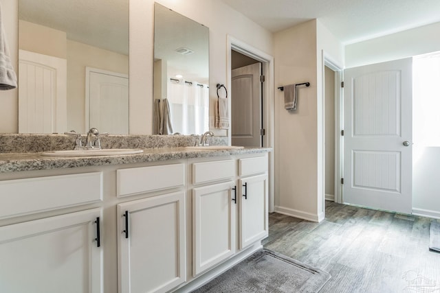 bathroom featuring vanity and hardwood / wood-style floors