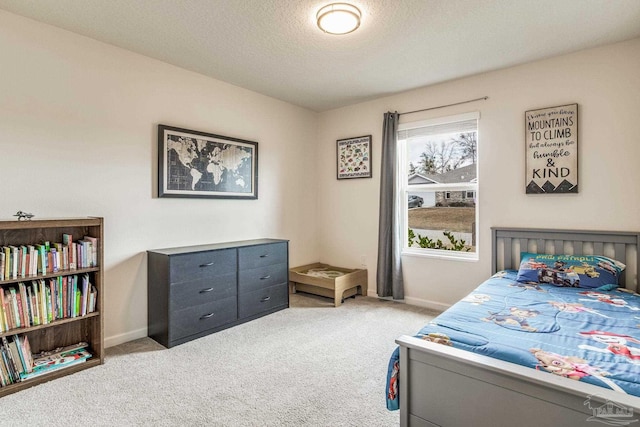 bedroom with light carpet and a textured ceiling