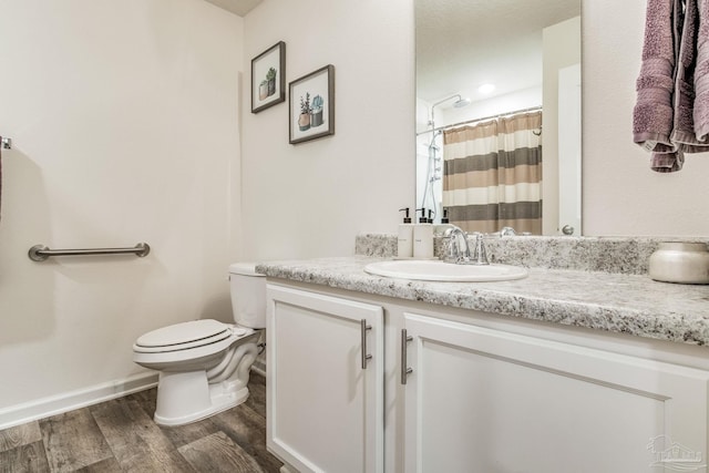 bathroom with vanity, wood-type flooring, and toilet