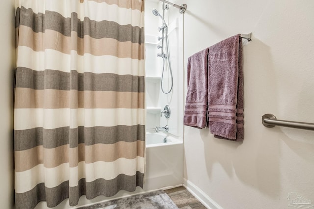 bathroom with wood-type flooring and shower / bath combo