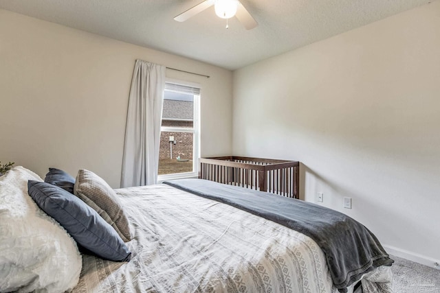 carpeted bedroom with a textured ceiling and ceiling fan