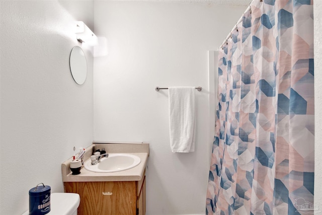 bathroom featuring vanity, a shower with curtain, and toilet