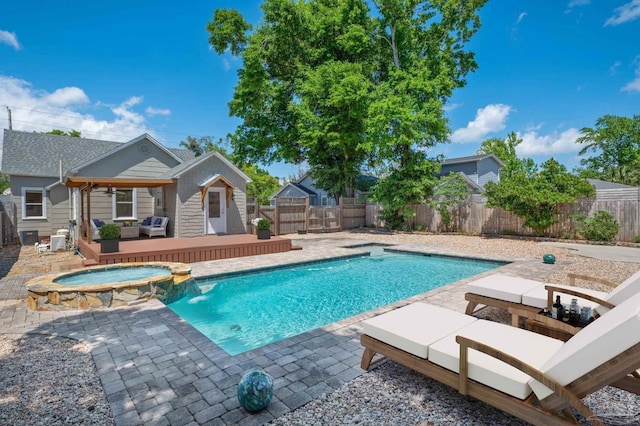 view of pool with an outdoor living space, a patio area, pool water feature, and an in ground hot tub