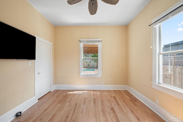 spare room featuring light hardwood / wood-style flooring and ceiling fan