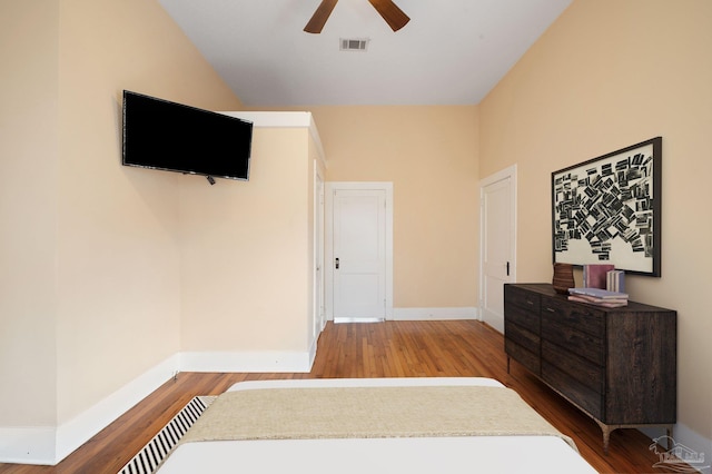 bedroom with hardwood / wood-style flooring, ceiling fan, and vaulted ceiling