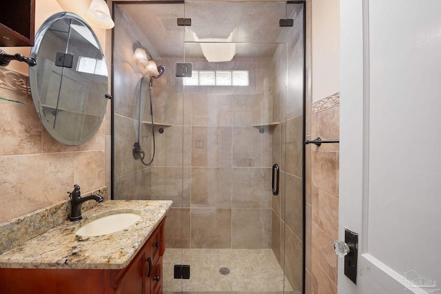 bathroom featuring vanity and a shower with door