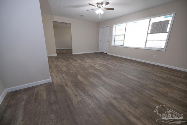 empty room featuring ceiling fan and dark hardwood / wood-style flooring