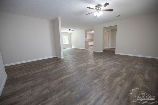 unfurnished living room with dark wood-type flooring and ceiling fan