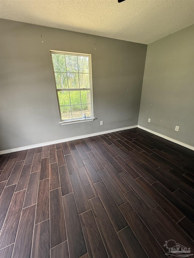 7030 Mcelhaney Rd, Century, FL 32535 - empty room featuring wood finished floors and a textured ceiling