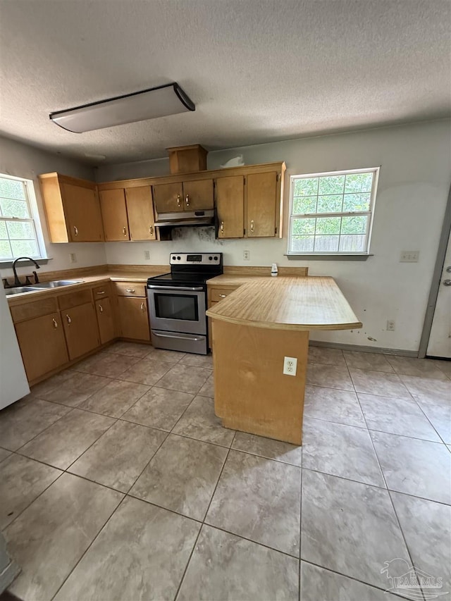 7030 Mcelhaney Rd, Century, FL 32535 - kitchen featuring stainless steel electric range oven, under cabinet range hood, healthy amount of natural light, a textured ceiling, and light tile patterned flooring