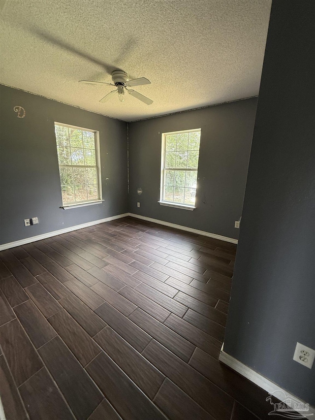 7030 Mcelhaney Rd, Century, FL 32535 - spare room with wood finish floors, a textured ceiling, and a ceiling fan