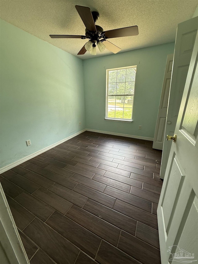 7030 Mcelhaney Rd, Century, FL 32535 - empty room featuring wood finish floors, ceiling fan, and a textured ceiling