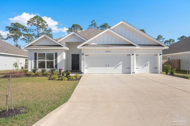 view of front of property featuring a garage and a front lawn