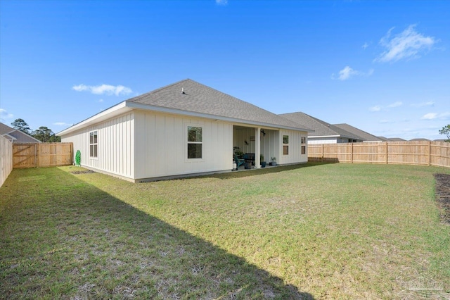 back of house featuring a yard