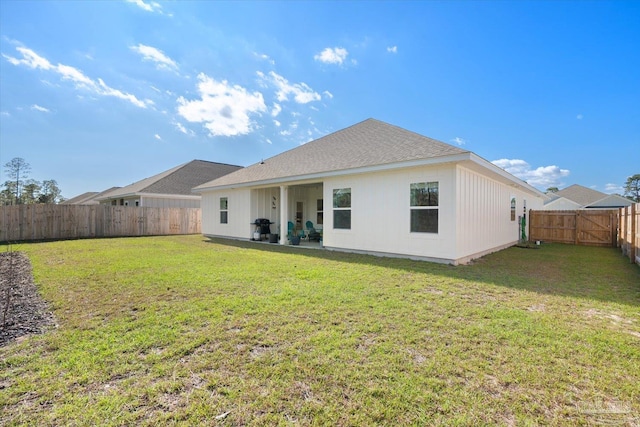 rear view of house with a yard and a patio area